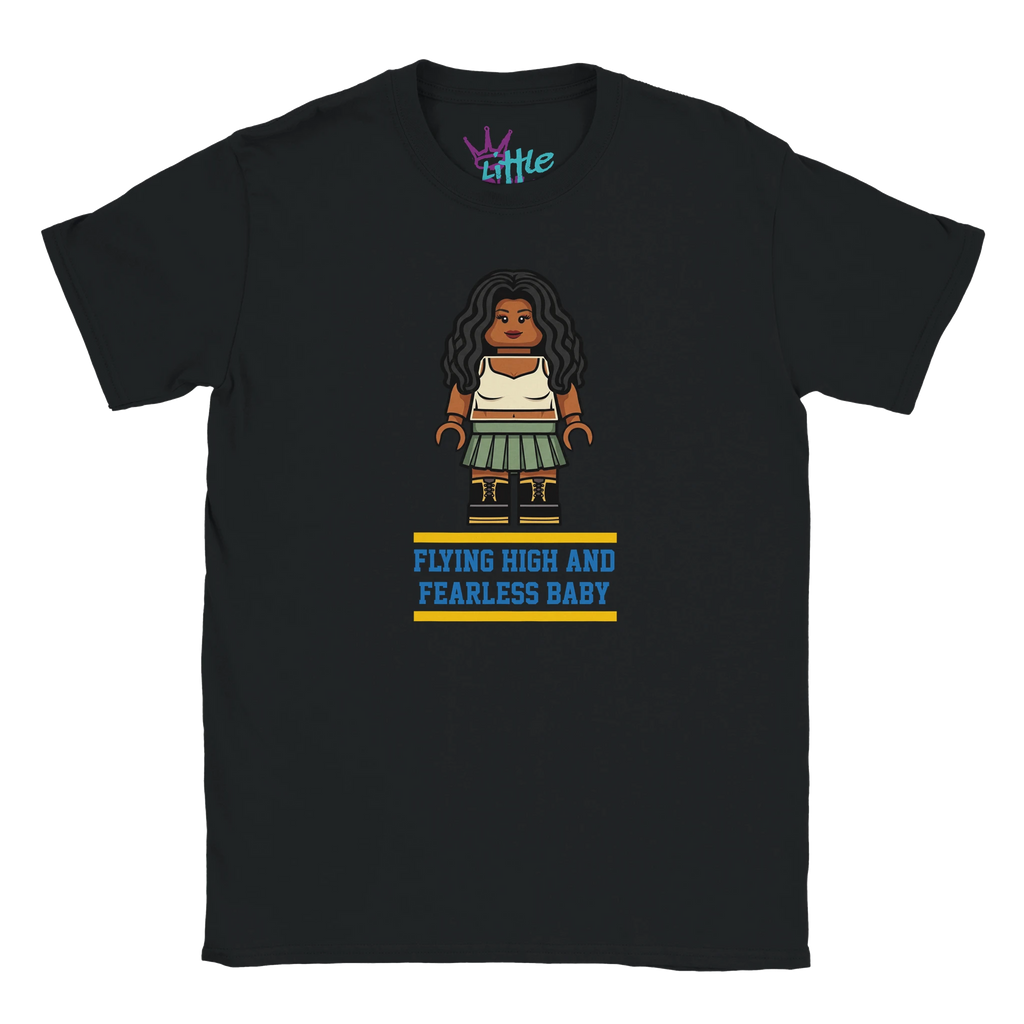 The Brick Ctrl Soul x Blocks Kids T-Shirt by Little Cult features block-style art of a woman with long dark hair, cream top, green skirt, and “FLYING HIGH AND FEARLESS BABY” in blue/yellow. Part of the Little Cult Blocks Collection.