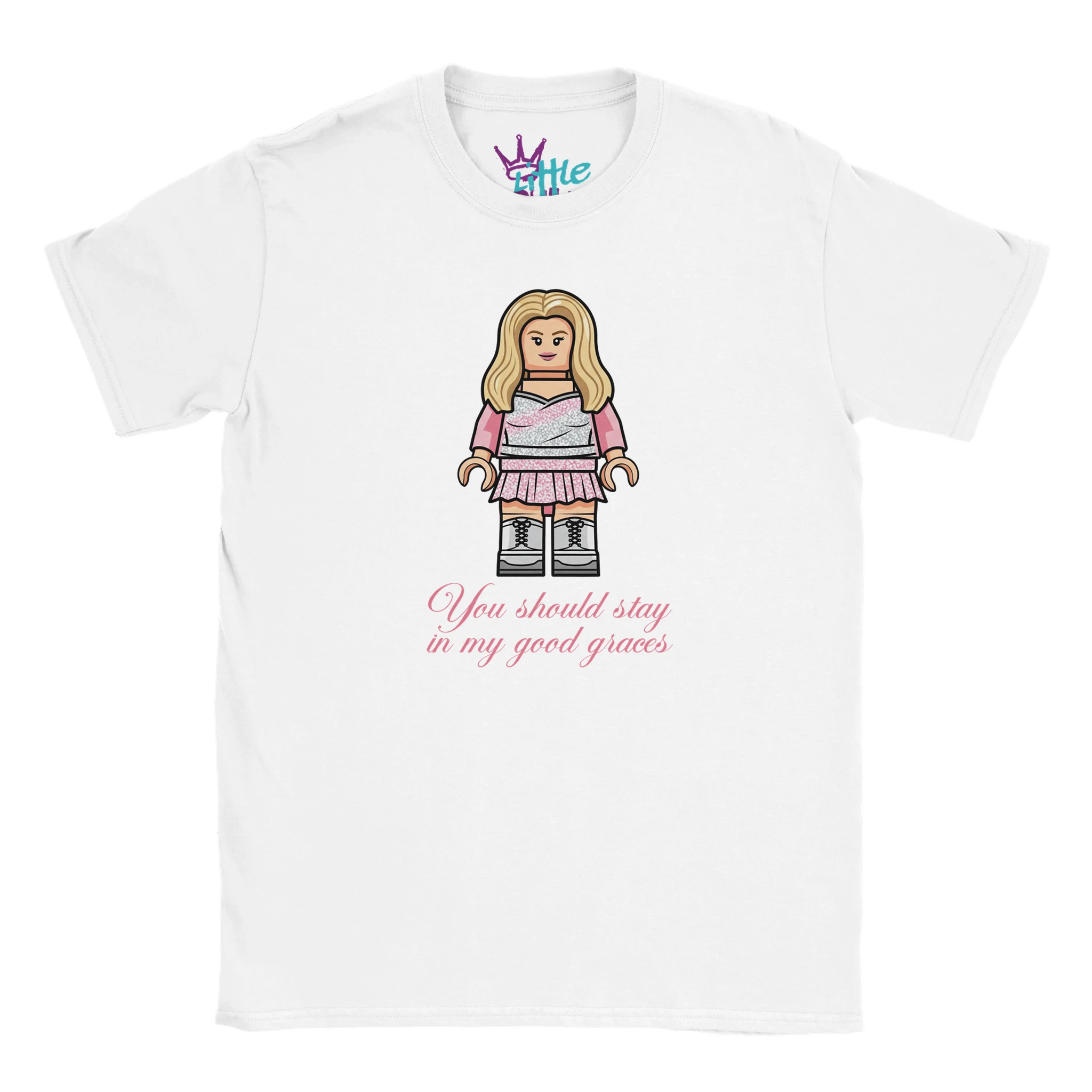 The Little Cult Brick Espresso Pop Idol x Blocks Kids T-Shirt is a white tee with a LEGO-style woman in pink, inspired by Sabrina Carpenter, and "You should stay in my good graces" in pink script. Part of the Blocks Collection.